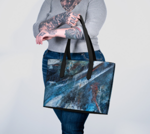 Model carrying Vegan Leather Tote with beautiful abstract artwork print